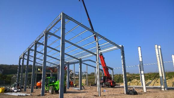 a steel frame structure on a building site on top of developed ground